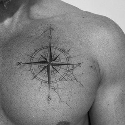 Fine line compass rose chest tattoo