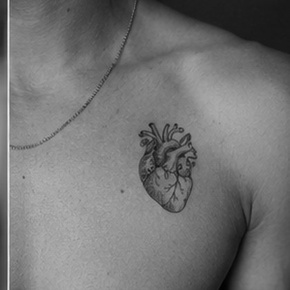 Anatomical heart chest tattoo in black and grey
