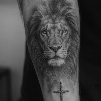 Black and grey realism lion forearm tattoo