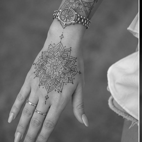 Ornamental mandala hand tattoo