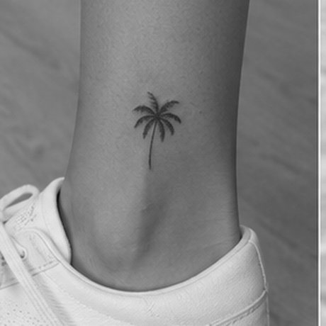 Small palm tree tattoo on an ankle