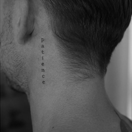 Fine line lettering neck tattoo reading patience